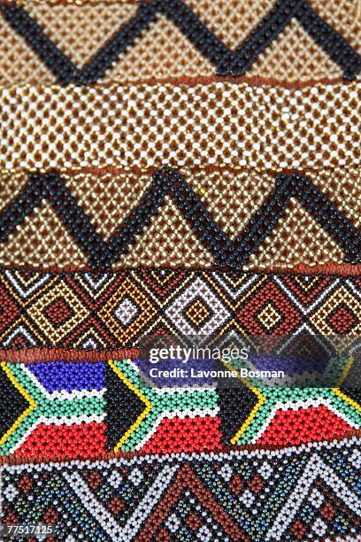 display of rows of african traditional beaded wristbands including the south african flag. cape town, western cape province, south africa - beaded bracelet stock pictures, royalty-free photos & images