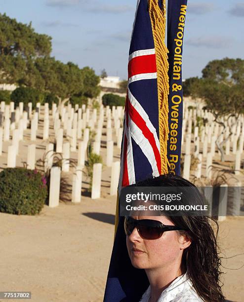 Royal British Legion National Standard Bearer Julia Poulter from London, practices in the British Commonwealth cemetery at the World War II battle...