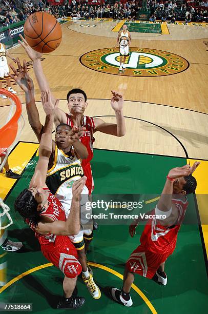 Kevin Durant of the Seattle SuperSonics puts a shot up over Yao Ming, Tracy McGrady and Luis Scola of the Houston Rockets during the game at Key...