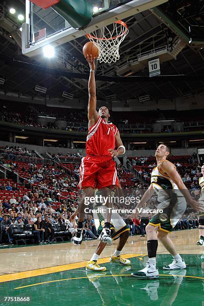 Tracy McGrady of the Houston Rockets lays the ball up over Nick Collison of the Seattle SuperSonics during the game at Key Arena on October 20, 2007...