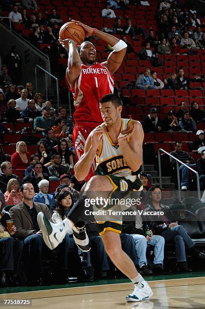 Tracy McGrady of the Houston Rockets shoots over Nick Collison of the Seattle SuperSonics during the game at Key Arena on October 20, 2007 in...