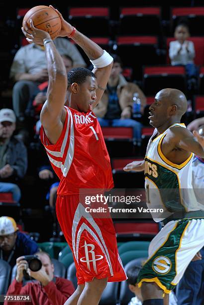 Tracy McGrady of the Houston Rockets comes under pressure from Damien Wilkins of the Seattle SuperSonics during the game at Key Arena on October 20,...