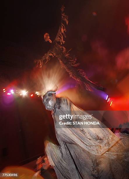 Masked ghoul walks under a huge floating figure during the "Halloween Extravaganza & Procession of the Ghouls" 26 October 2007 in The Cathedral...