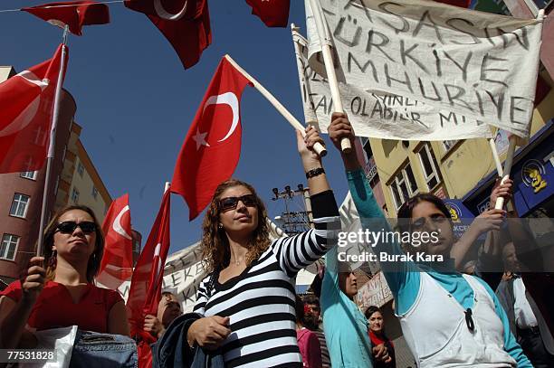 Protestors hold banners and Turkish flags aloft and shout slogans against the outlawed Kurdistan Workers Party on October 27, 2007 in dowtown Sirnak...