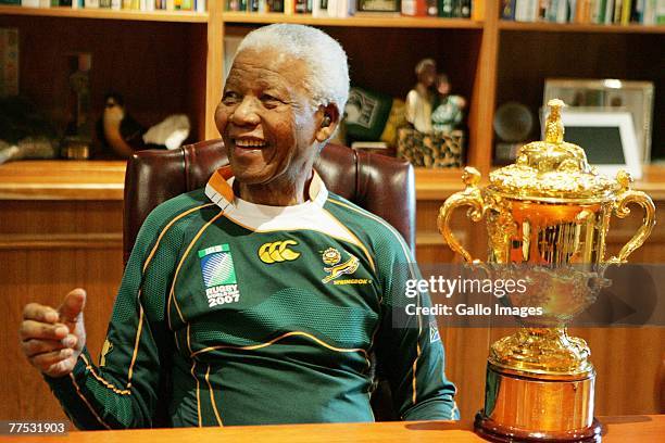 Former South Africa President Nelson Mandela poses with the Webb-Ellis cup during the Springboks visit to Nelson Mandela at his residence on October...