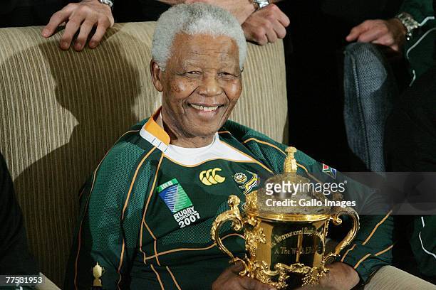 Former South Africa President Nelson Mandela poses with the Webb-Ellis cup during the Springboks visit to Nelson Mandela at his residence on October...