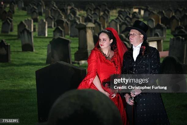 Goths Tony and Angela Lightowler pose for wedding pictures after renewing their marriage vows at St Mary The Virgin Church during Whitby Gothic...