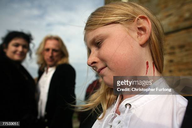 Guest complete with a fake vampire bite on her neck arrives for the renewal of Goths Tony and Angela Lightowler's marriage vows at St Mary The Virgin...