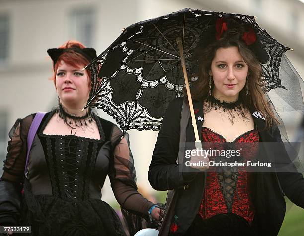 Two goths walk along the promenade during Whitby Gothic Weekend on October 26, 2007 in Whitby, England. Whitby Gothic Weekend which started in 1994...