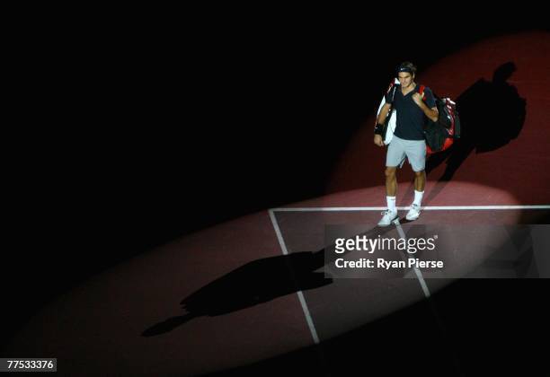 Roger Federer of Switzerland walks onto the court before his Semi Final singles match against Ivo Karlovic of Croatia during Day Five of the ATP...