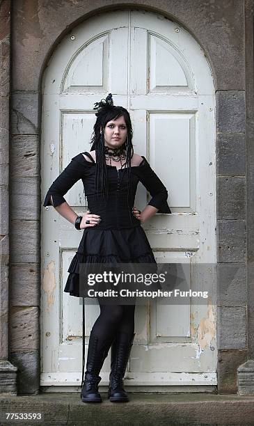 Goth Kate Cherrell watches people promenade during Whitby Gothic Weekend on October 27 Whitby, England. Whitby Gothic Weekend which started in 1994...