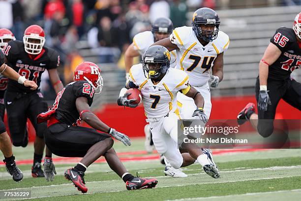 Running back Noel Devine of the West Virginia Mountaineers runs against Devin McCourty of the Rutgers University Scarlet Knights on October 27, 2007...