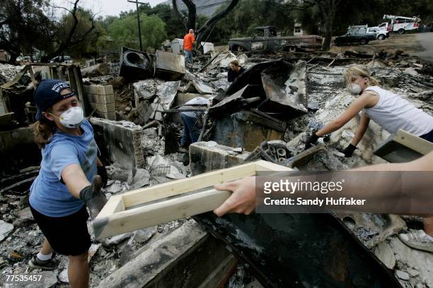 Residents sort through debris of their burned-out home October 27, 2007 in the Del Dios area of in Escondido, California. Firefighters are gaining...