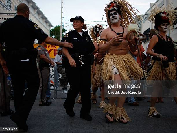 Revelers participate in the Fantasy Fest Masquerade March October 27, 2007 in Key West, Florida. The 10-day costuming and masking festival ends...