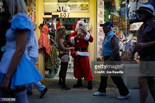 Sue Nelson and Anthony Nelson, dressed as Santa Claus, participate in the Fantasy Fest Masquerade March October 27, 2007 in Key West, Florida. The...