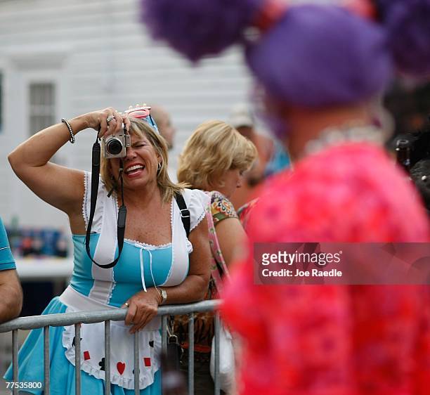 People take photographs of a person dressed in a costume as they participate in the Fantasy Fest Masquerade March in Key West, Florida October 27,...