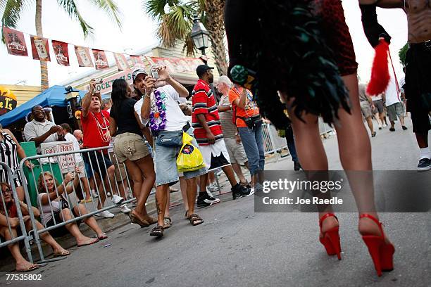 People take photographs of a person dressed in a costume as they participate in the Fantasy Fest Masquerade March in Key West, Florida October 27,...