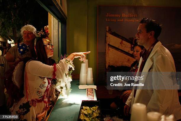 Woman in costume participating in the Fantasy Fest Masquerade March orders a drink from a bar tender October 27, 2007 in Key West, Florida. The ten...