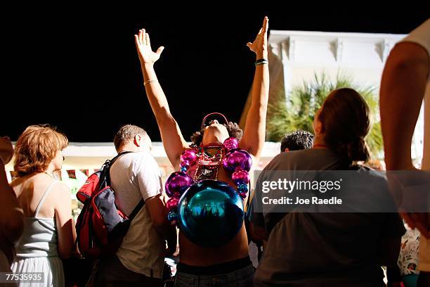 Man participating in the Fantasy Fest Masquerade March tries to catch beads being thrown as he wears his costume October 27, 2007 in Key West,...