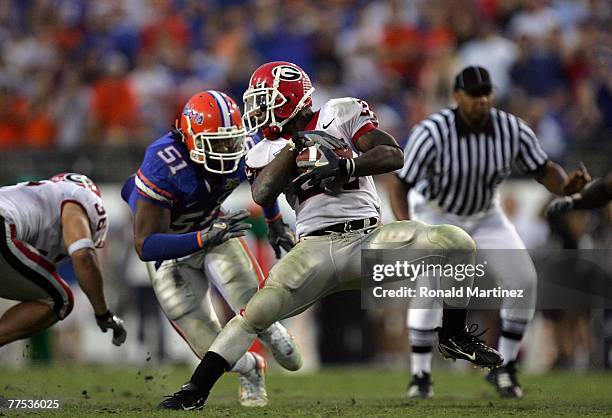 Tailback Knowshon Moreno of the Georgia Bulldogs runs the ball against Brandon Spikes of the Florida Gators at Jacksonville Municipal Stadium on...