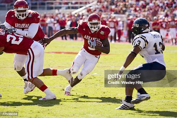 Darren McFadden of the Arkansas Razorbacks runs with the ball against the Florida International Golden Panthers at Donald W. Reynolds Stadium October...