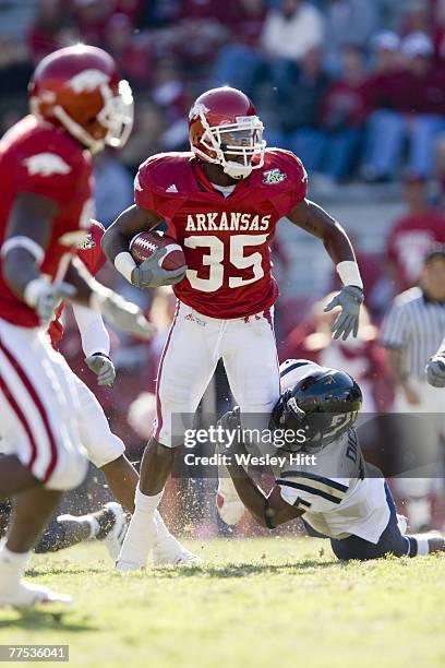 Rashaad Johnson of the Arkansas Razorbacks is tackled after intercepting a pass against the Florida International Golden Panthers at Donald W....
