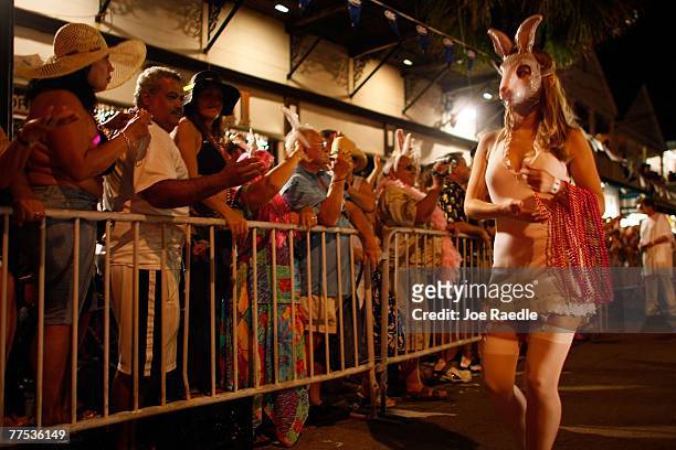 Woman hands out beads as she walks though the streets during the Fantasy Fest Masquerade parade October 27, 2007 in Key West, Florida. The ten day...