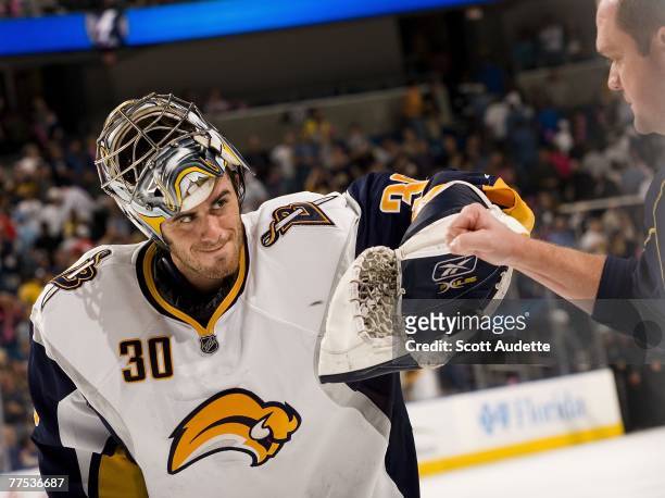 Goalie Ryan Miller of the Buffalo Sabres celebrates with a Buffalo trainer after defeating the Tampa Bay Lightning in overtime at St. Pete Times...