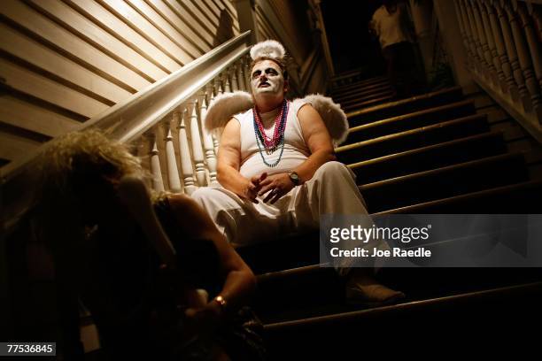 Don Bellucci sits on steps while attending the Fantasy Fest parade October 27, 2007 in Key West, Florida. The ten day costuming and masking festival...