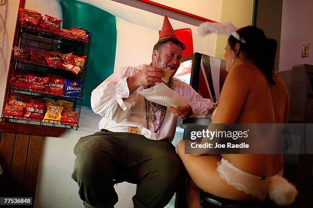 Clint Henry and Aryn Allison eat pizza together as they attend the Fantasy Fest parade October 27, 2007 in Key West, Florida. The ten day costuming...