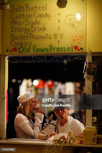 Tammy Farrell and Danielle Savage wait for their order at a restaurant as they visit the Fantasy Fest parade October 27, 2007 in Key West, Florida....