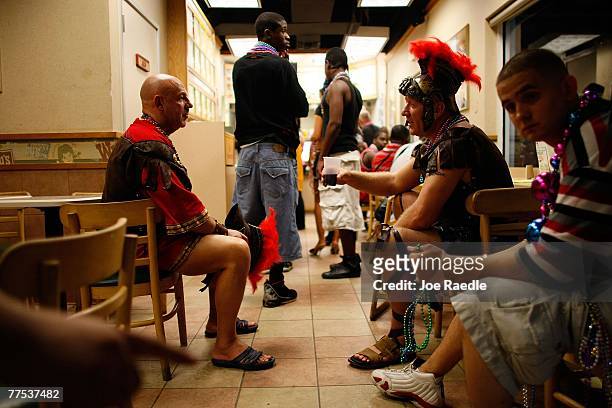 Victor Dvorkin and Victor Medved dressed as Roman soliders sit in Wendy's as they wait for their order during their visit to Fantasy Fest parade...