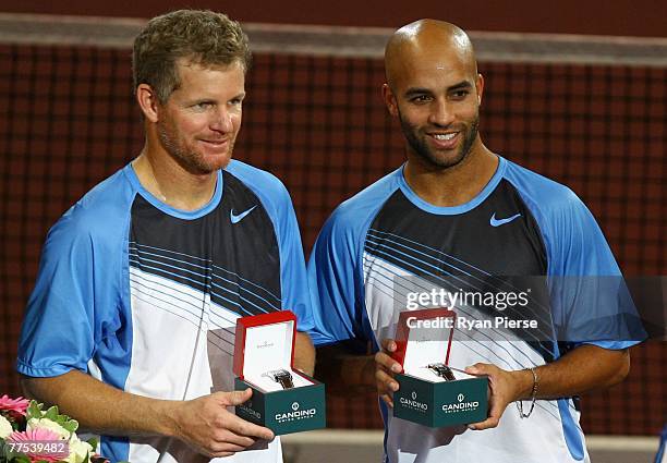 Mark Knowles of the Bahamas and James Blake of the USA hold their runners up prizes after the Doubles Final against Mike Bryan and Bob Bryan of the...