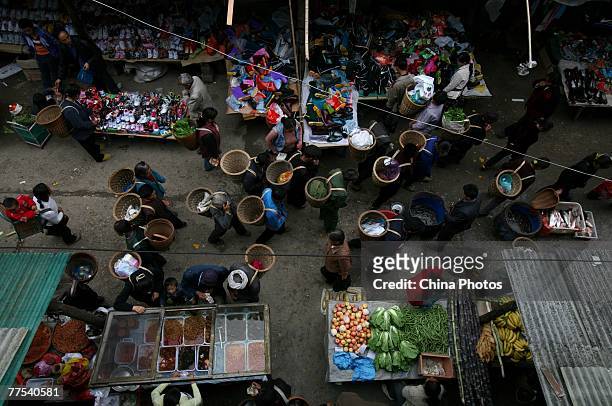 Villagers of Tu ethnic group shop in a market on October 27, 2007 in Yongshun County of Hunan Province, China. The history of Tu ethnic group can be...