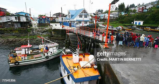 Children from the small fishing town of Puerto Aguirre, in the Chilean Patagonia, wait for the passengers of the cruise Skorpios, 1500 km south of...