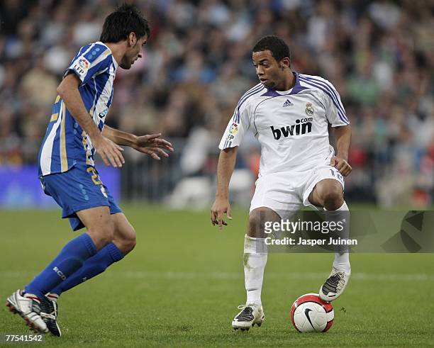 Marcelo of Real Madrid duels for the ball with Juan Rodriguez of Deportivo la Coruna during the Spanish League match between Real Madrid and...