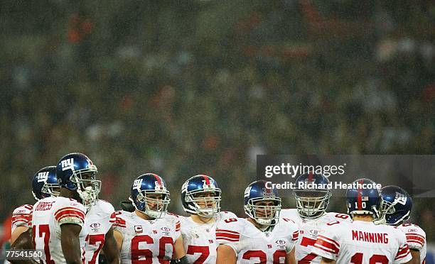 The Giants offence listens to their quarterback, Eli Manning during the NFL Bridgestone International Series match between New York Giants and Miami...