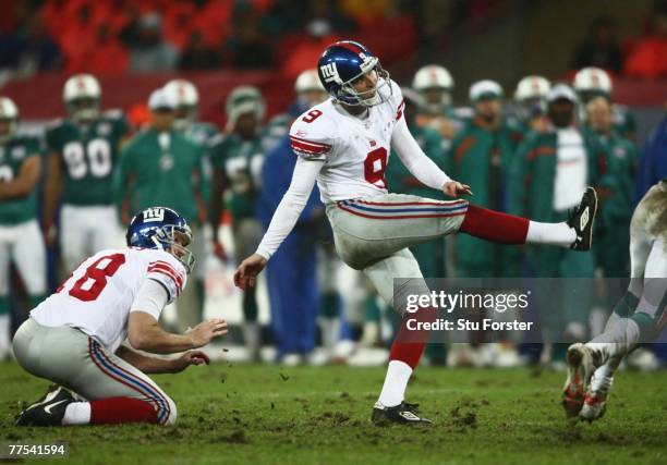 Kicker, Lawrence Tynes of the Giants kicks the extra point during the NFL Bridgestone International Series match between New York Giants and Miami...