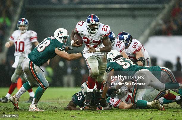 Brandon Jacobs of New York Giants scrambles during the NFL Bridgestone International Series match between New York Giants and Miami Dolphins at...