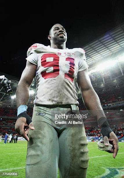 Justin Tuck of the Giants smiles as he walks of the field following his team's 13-10 victoryduring the NFL Bridgestone International Series match...