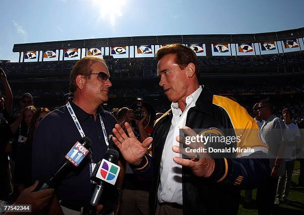 California Governor Arnold Schwarzenegger speaks with San Diego Charger Owner Dean Spanos before the start of the Houston Texans against the San...