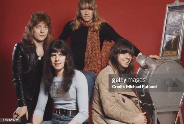 British glam rock band Sweet posed together with a Mutoscope in London, 13th January 1976. The group are, from left to right: bassist Steve Priest,...