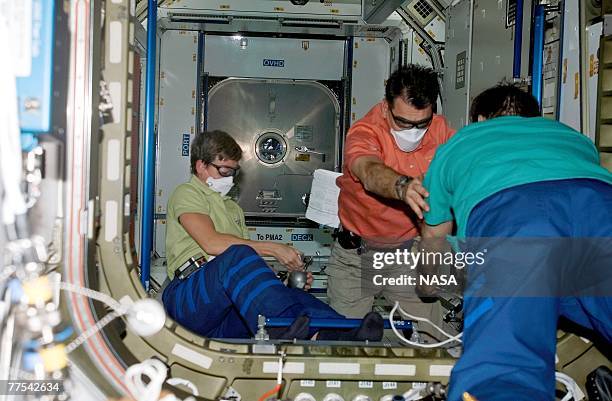 In this handout provided by NASA, Astronauts Peggy A. Whitson, Expedition 16 commander; European Space Agency's Paolo Nespoli, STS-120 mission...
