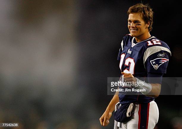 Tom Brady of the New England Patriots waits to congratulate teammate Matt Cassel after he scored a touchdown in the fourth quarter against the...