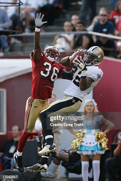 Wide receiver Marques Colston of the New Orleans Saints catches a 15-yard touchdown pass over defensive back Shawntae Spencer of the San Francisco...