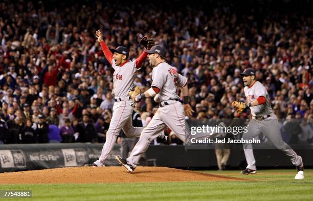 Dustin Pedroia, Julio Lugo and Mike Lowell of the Boston Red Sox celebrates after winning Game Four by a score of the 4-3 to win the 2007 Major...