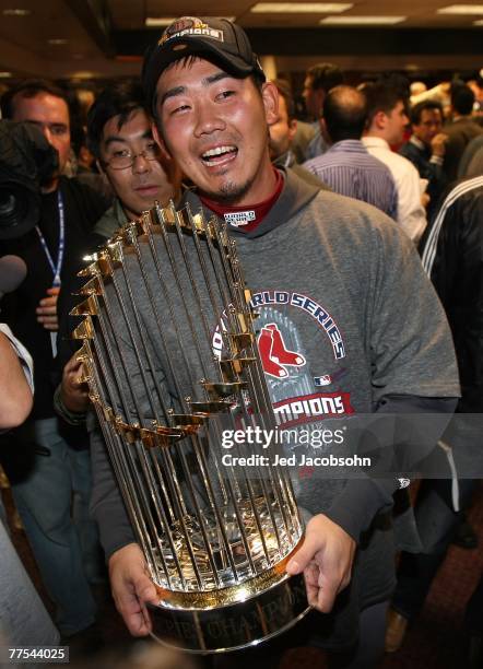 Daisuke Matsuzaka of the Boston Red Sox celebrates with the trophy in the locker room after winning Game Four by a score of 4-3 to win the 2007 Major...