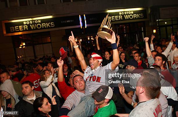 Fans celebrate on Brookline Avenue near Fenway Park after the Boston Red Sox defeated the Colorado Rockies 4-3 in Game Four of the World Series on...