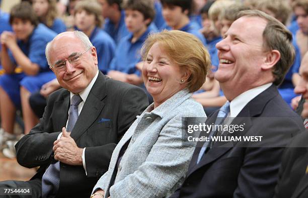 Australian Prime Minister John Howard shares a light moment with his wife Janette and Treasurer Peter Costello as he campaigns at St Joseph's College...