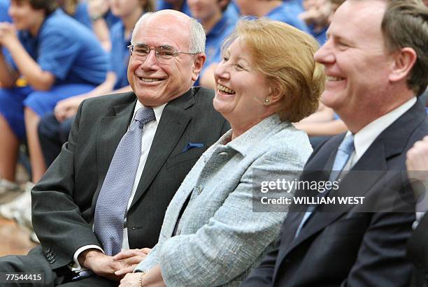 Australian Prime Minister John Howard shares a lighter moment with his wife Janette and Treasurer Peter Costello as he campaigns at St Joseph's...